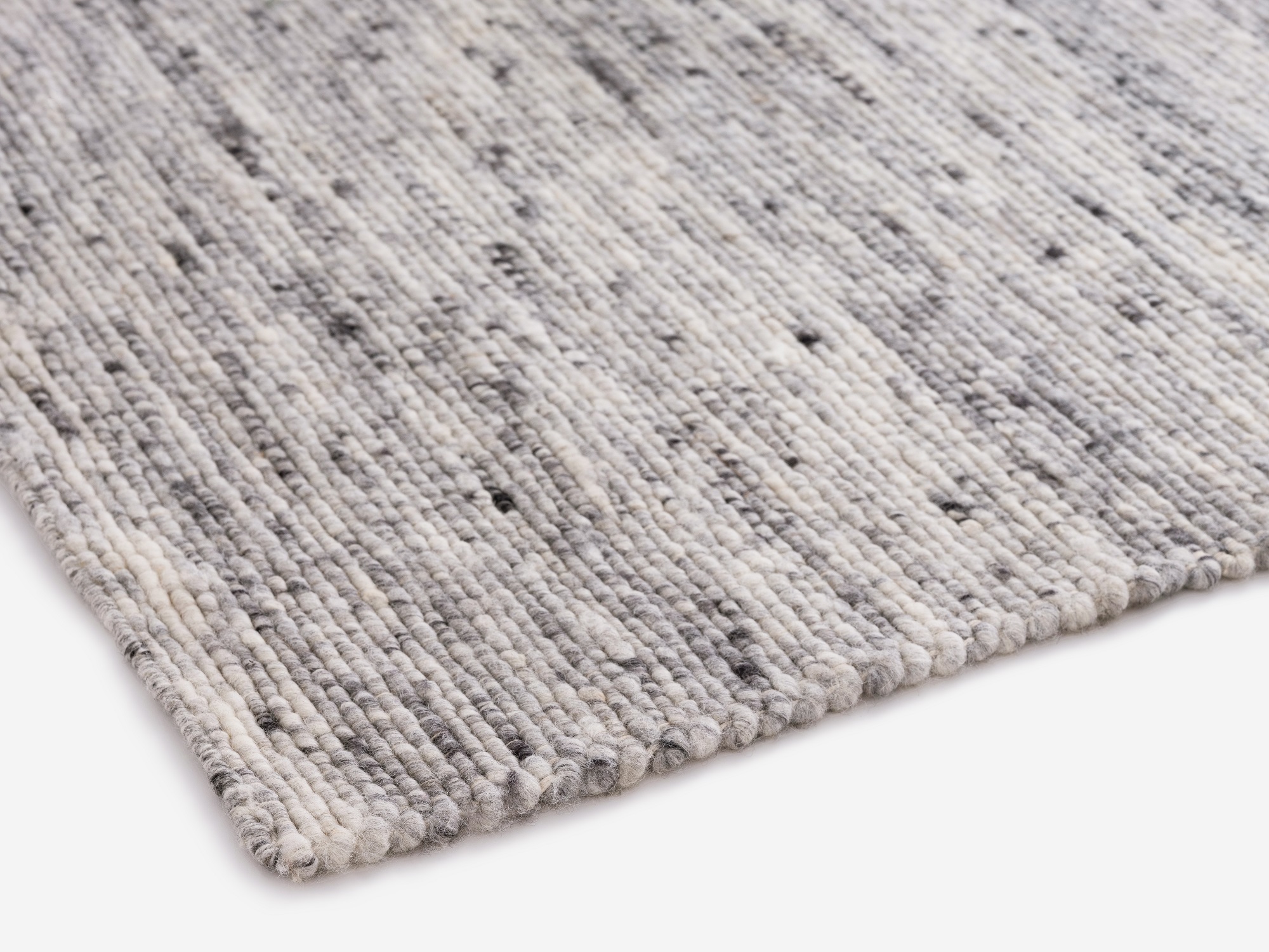 Corner detail view of light grey living room rug